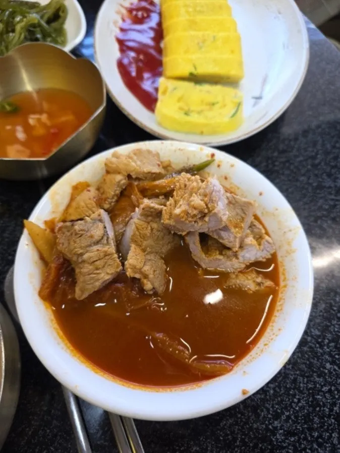 Kimchi jjigae topped with beef short ribs