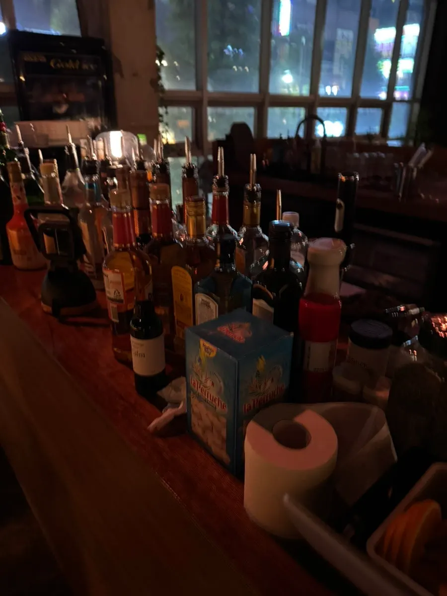 Whisky bottles on a lit wooden shelf