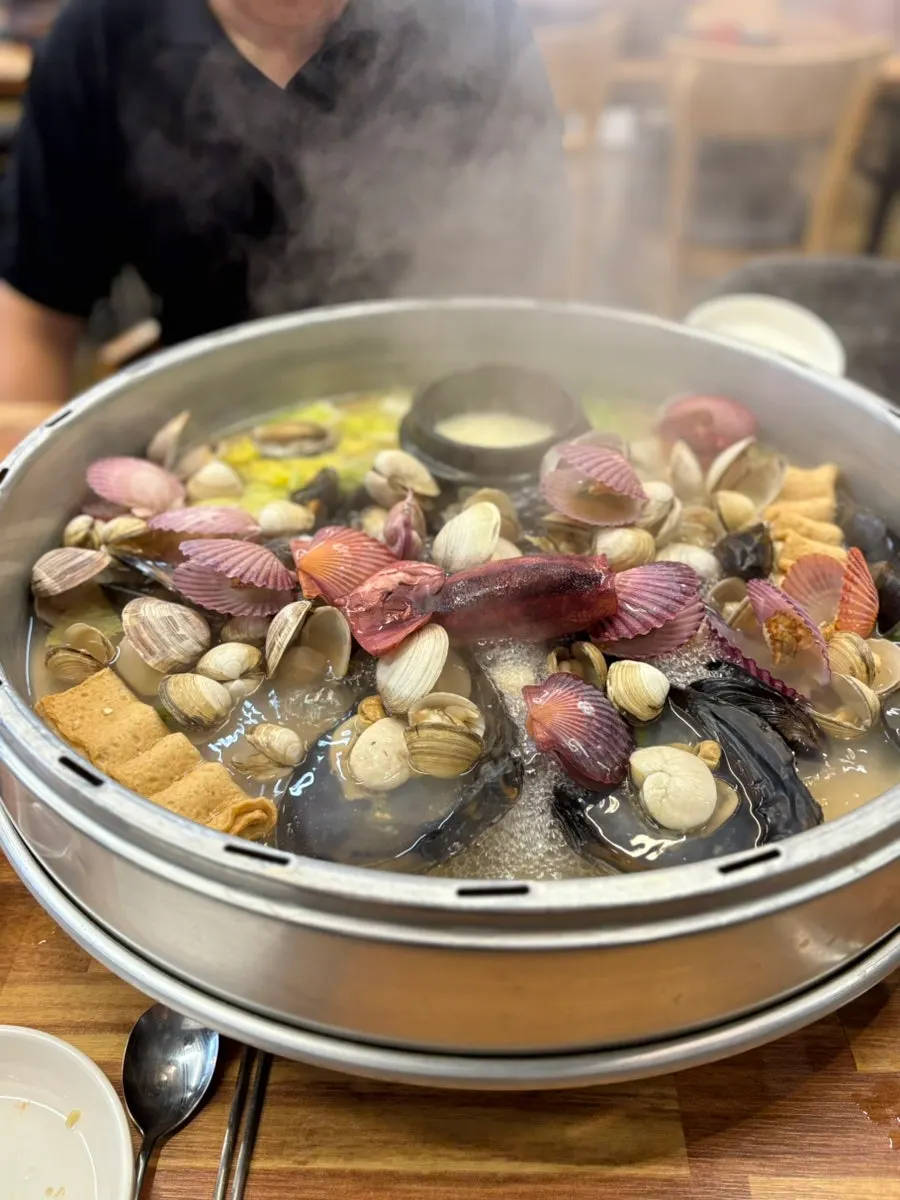 The clam hot pot boiling with the lid still on