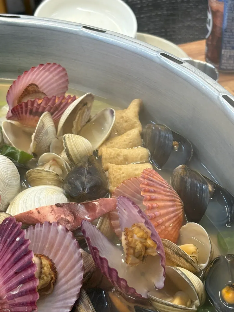 A single abalone portioned onto a plate for each person