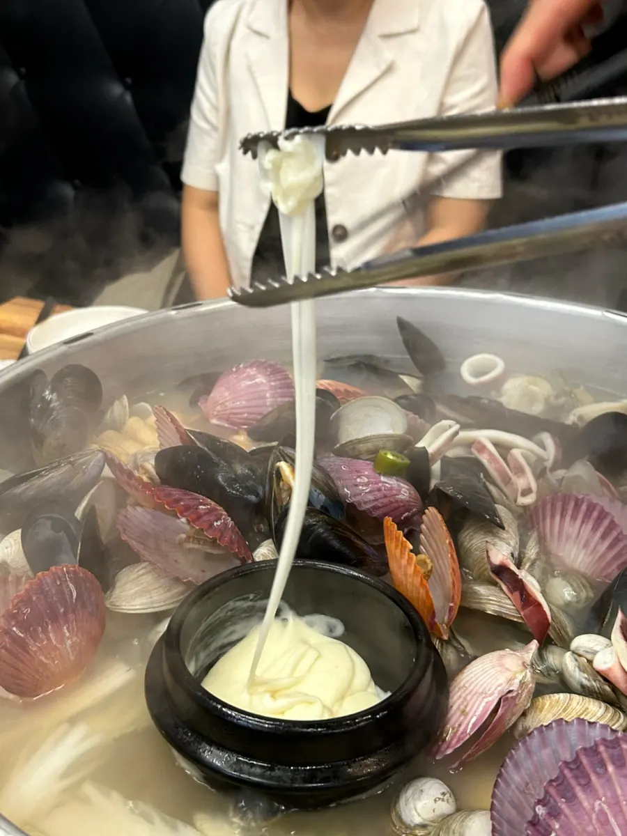 Close-up of melted cheese on the clam hot pot