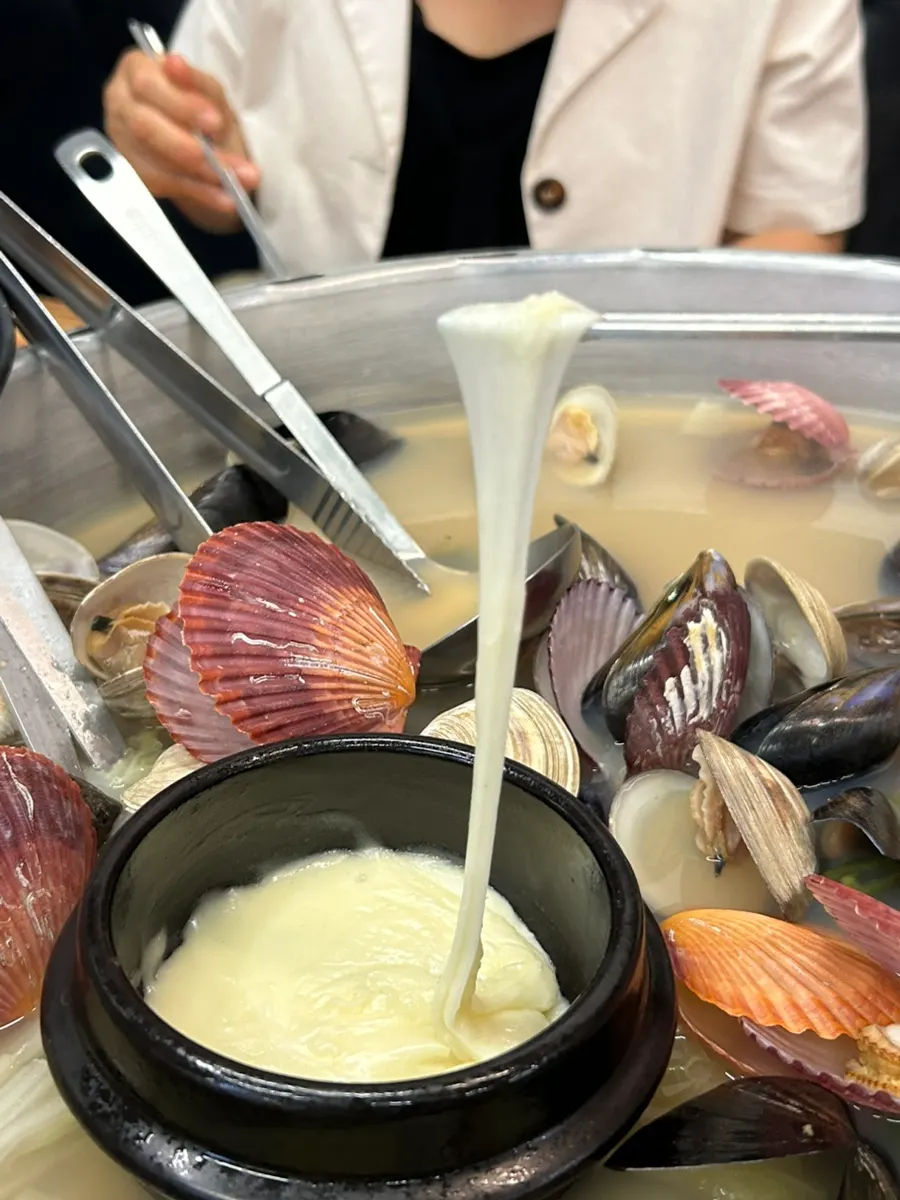 Seafood broth ladled out