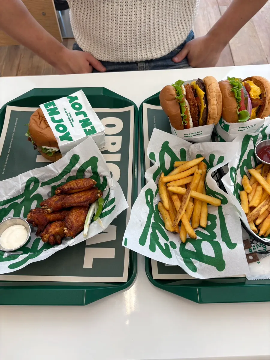 Burger sets and buffalo wings set out on the table