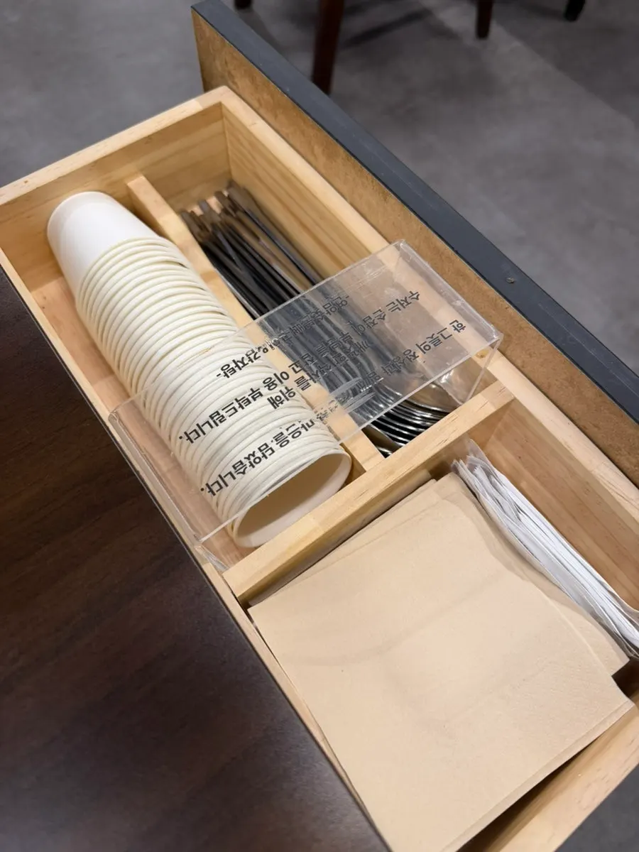 Table setting with a paper cup tucked inside