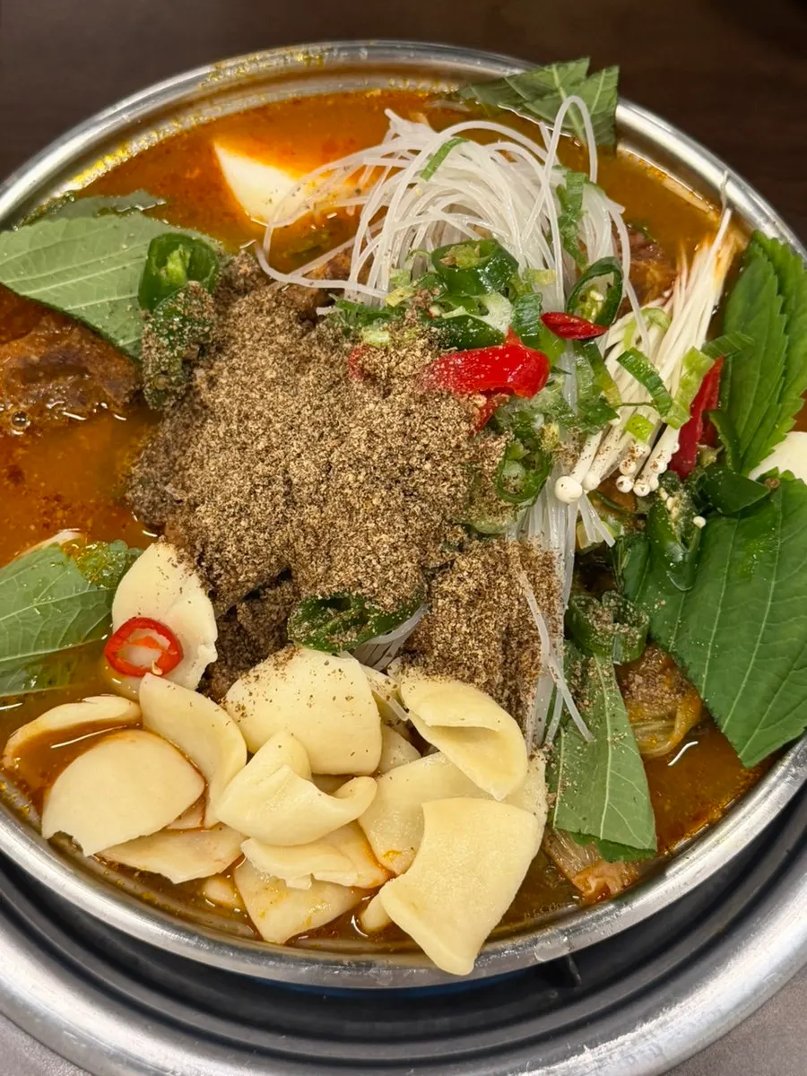 Gamjatang pot with glass noodles and sujebi