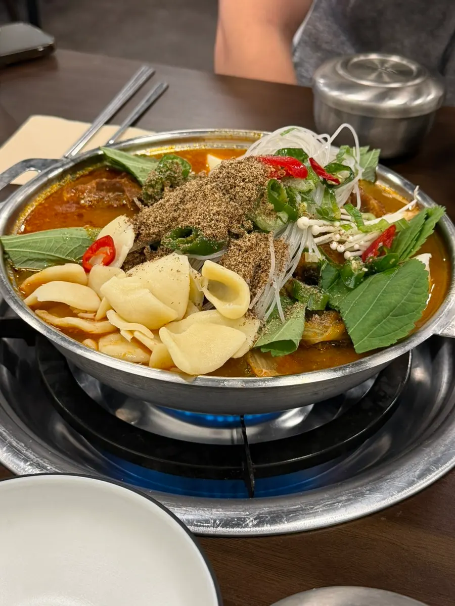 Close-up of gamjatang bubbling on the burner
