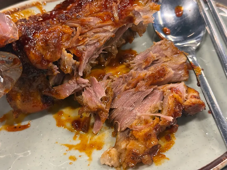 Pork bone grill meat with visible charcoal char marks