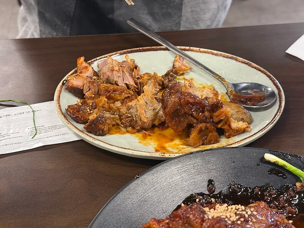 A piece of pork bone grill meat picked up with chopsticks