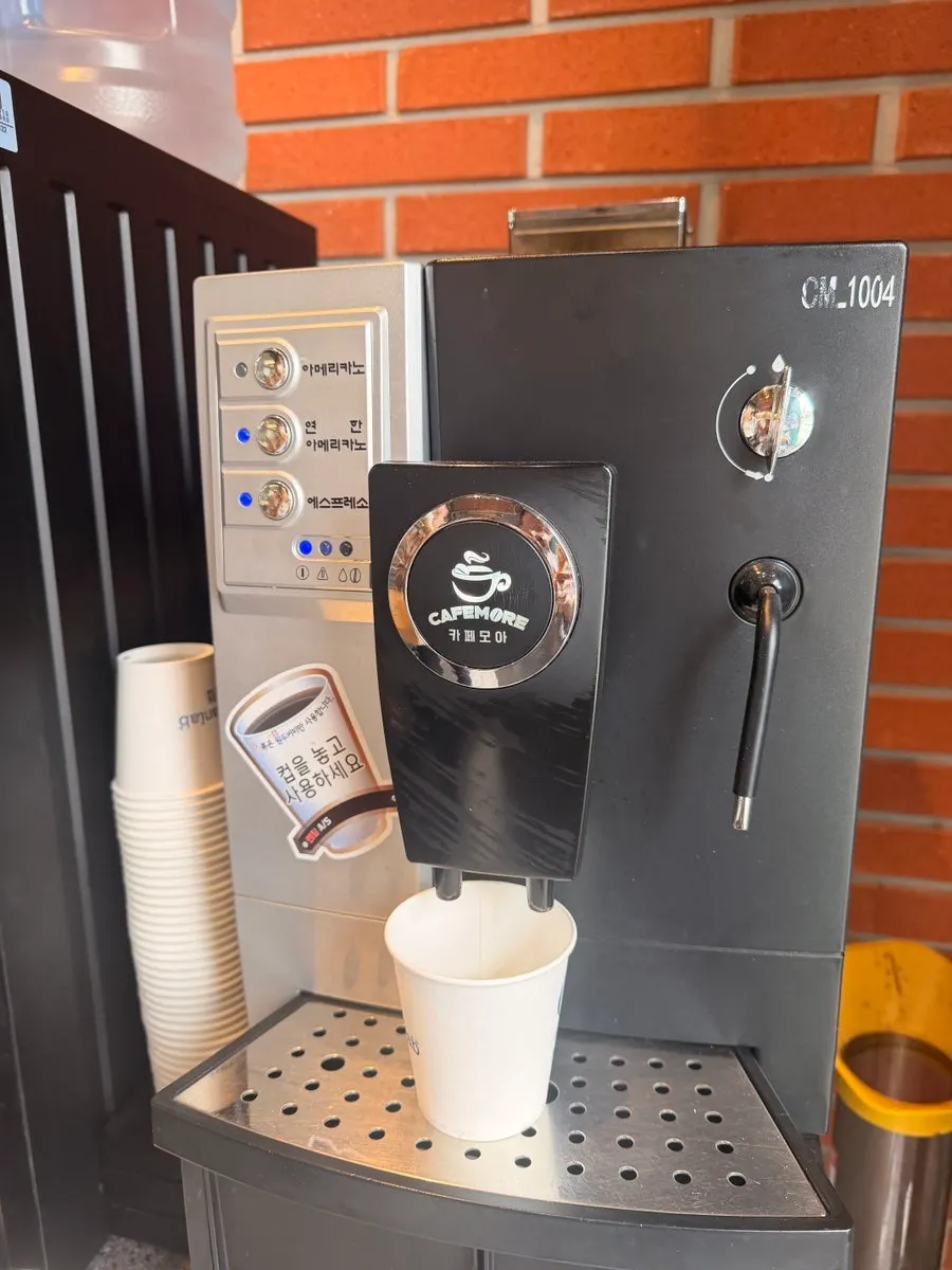 A cup of coffee poured from the machine