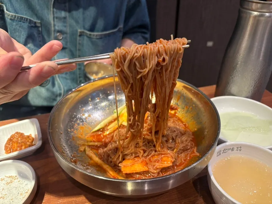 Bibim naengmyeon served alongside the pork belly