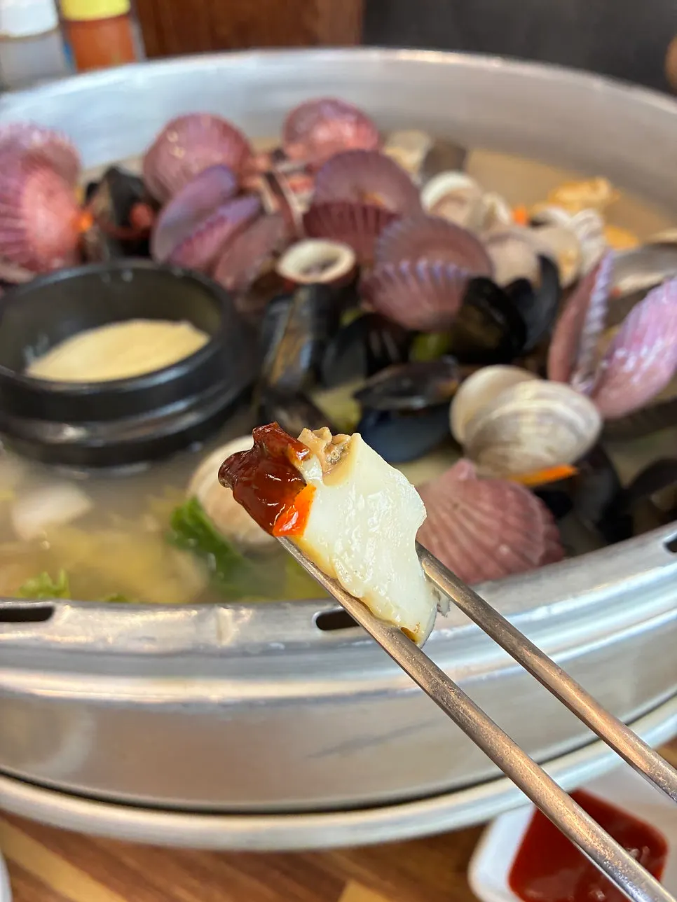 Clam meat dipped in wasabi soy sauce