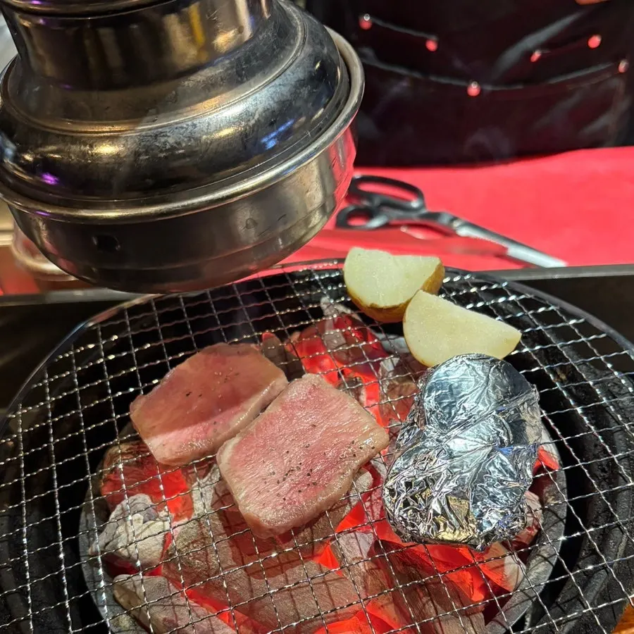 Beef tongue grilling over the charcoal fire