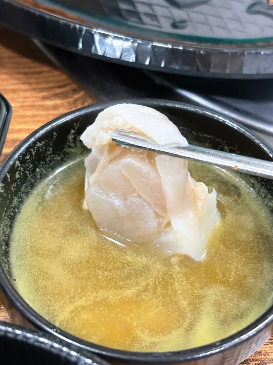 A piece of cartilage dipped in sauce