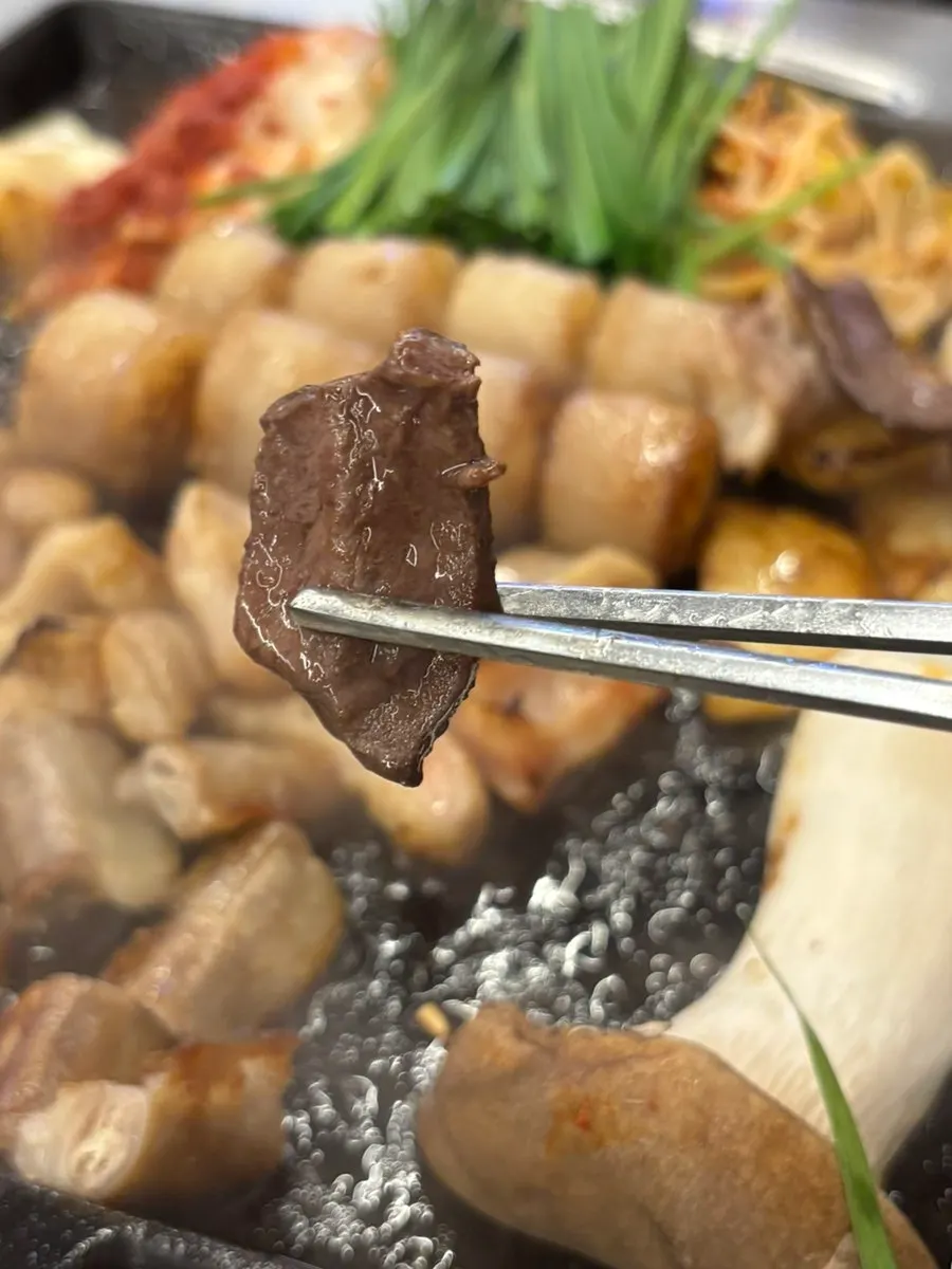 Staff grilling gopchang and yeomtong for the table
