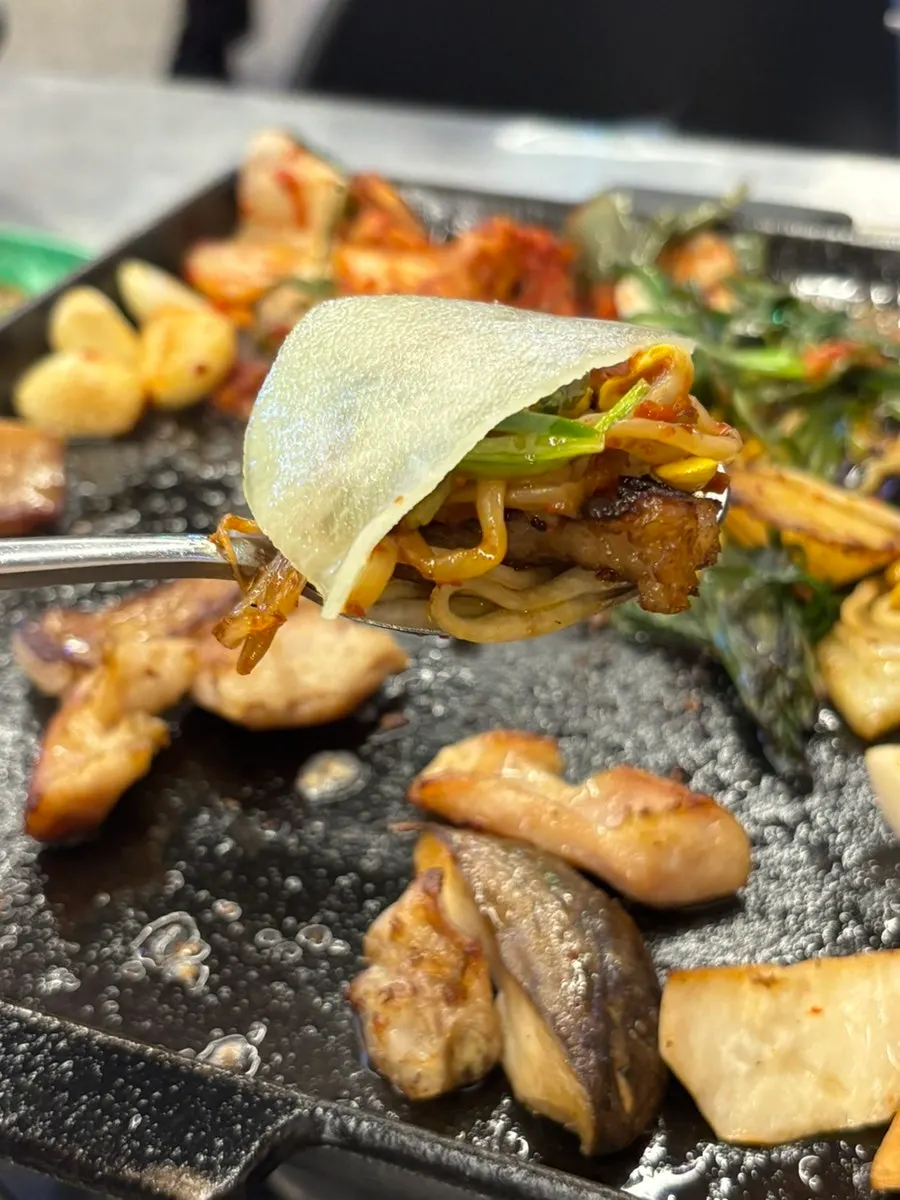 Gopchang paired with chives, bean sprouts, and kimchi