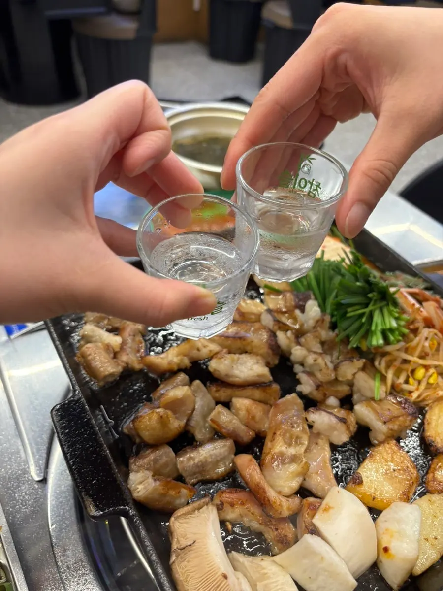 Grilled gopchang enjoyed with a glass of soju