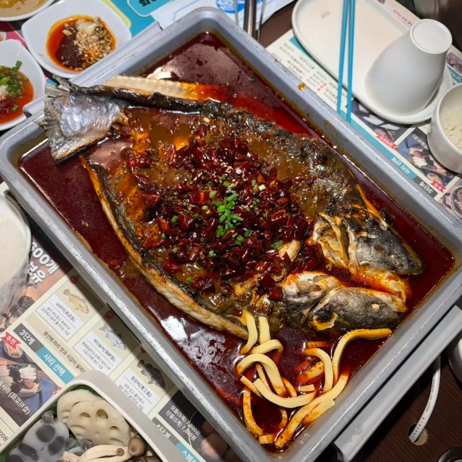 Large kaoyu fish served at the table