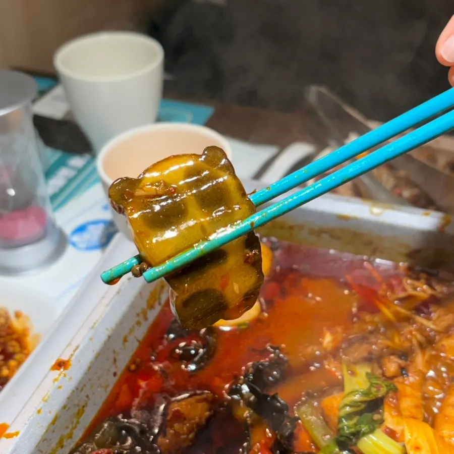 Vegetables and mushrooms cooking in the kaoyu broth