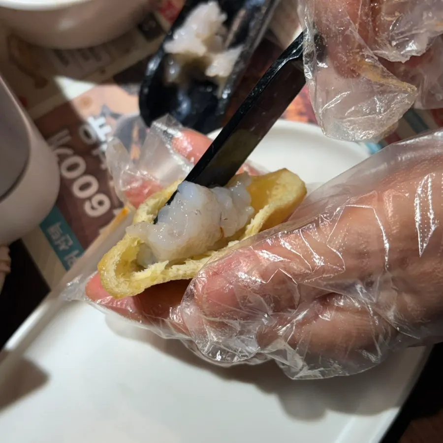 Plump shrimp balls lifted out of the broth