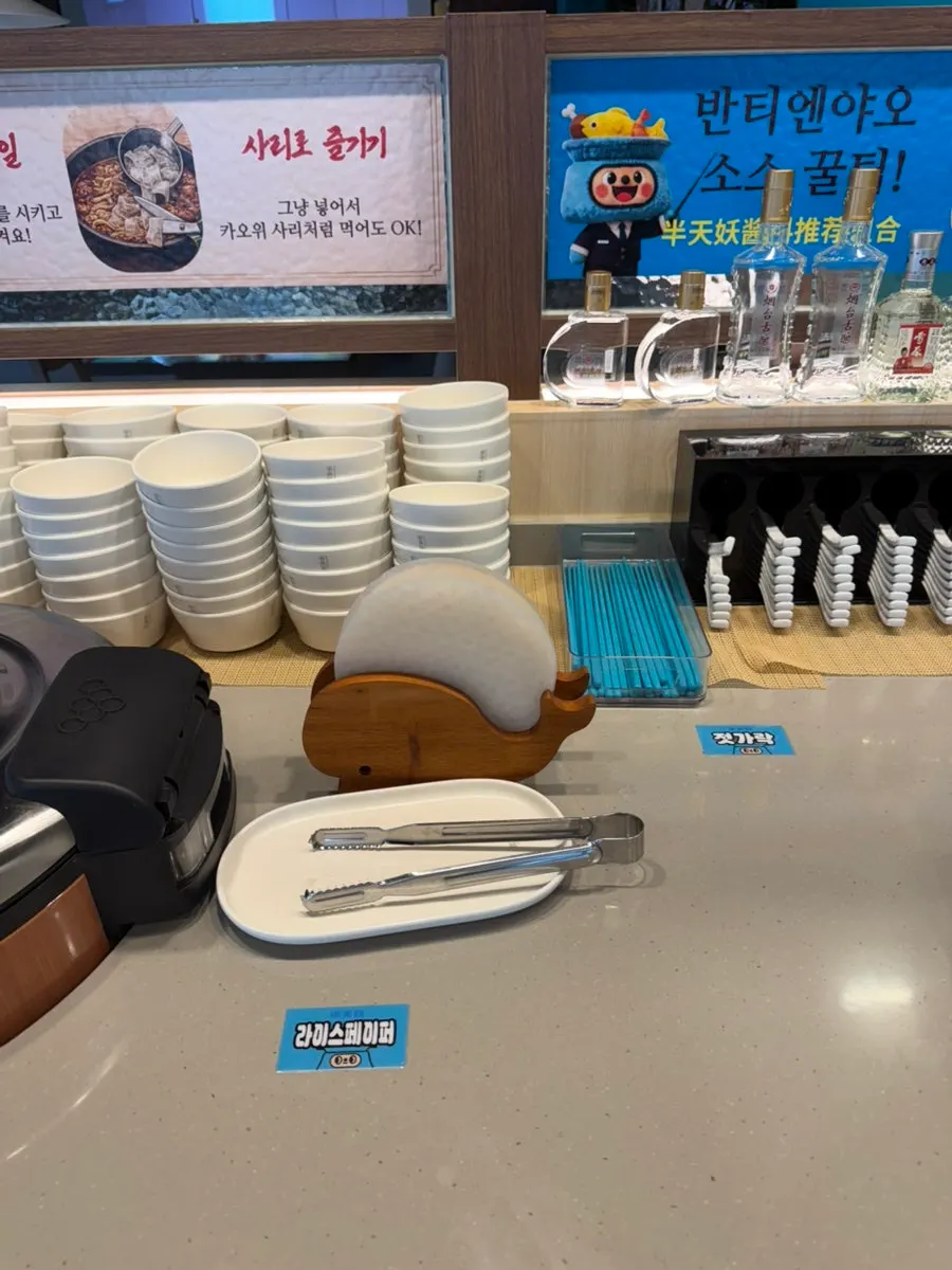 Various sauce containers set out at the self bar