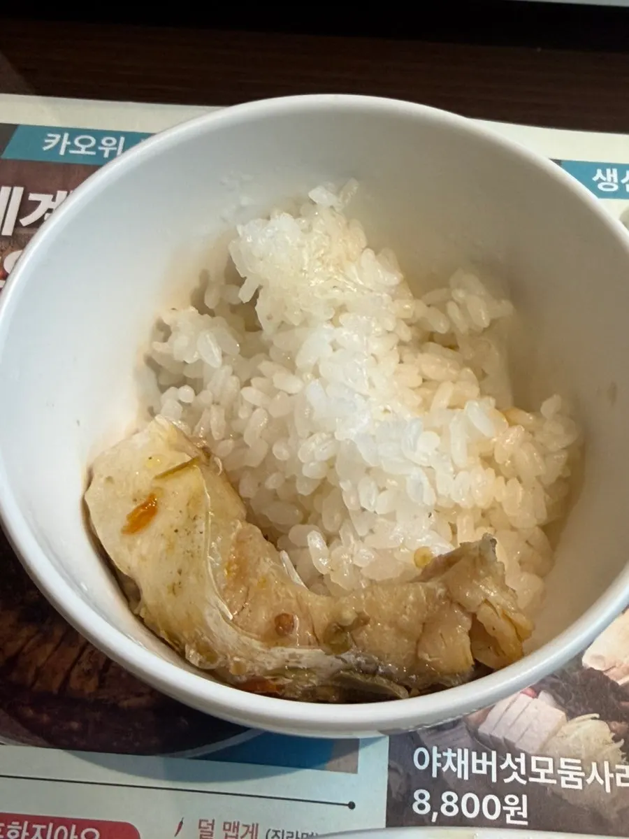 A piece of fish dipped in sauce