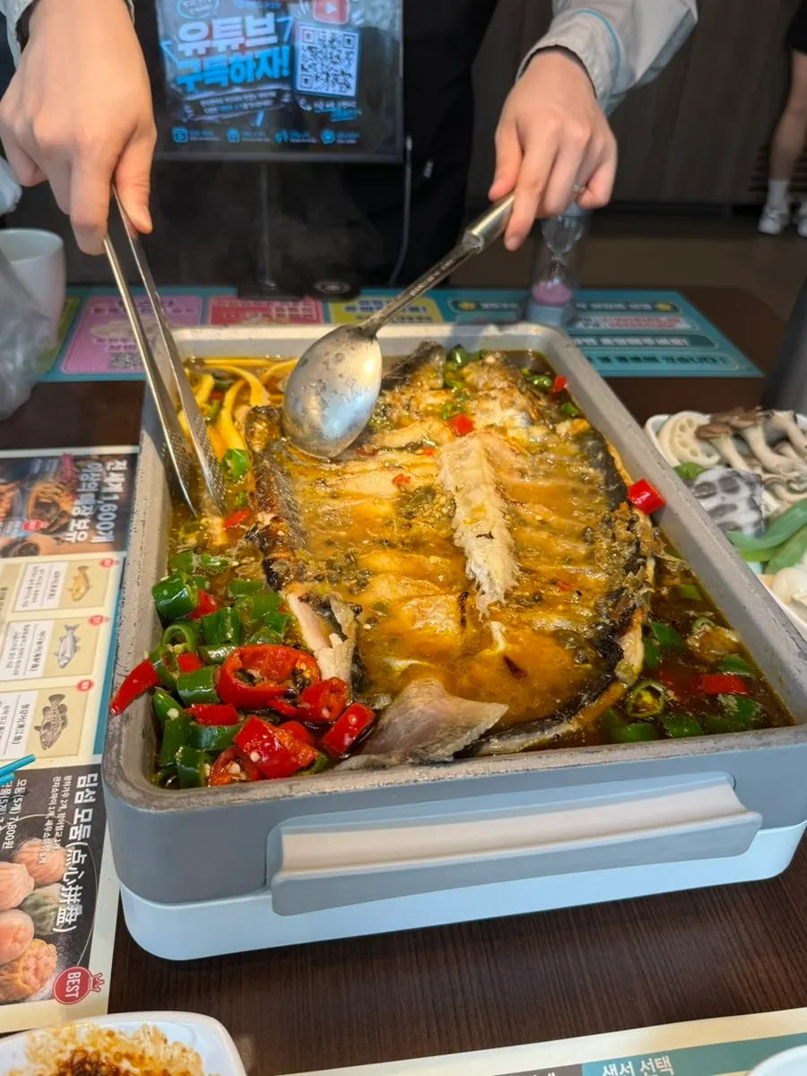 Staff member finishing prep on the ningbo fish kaoyu