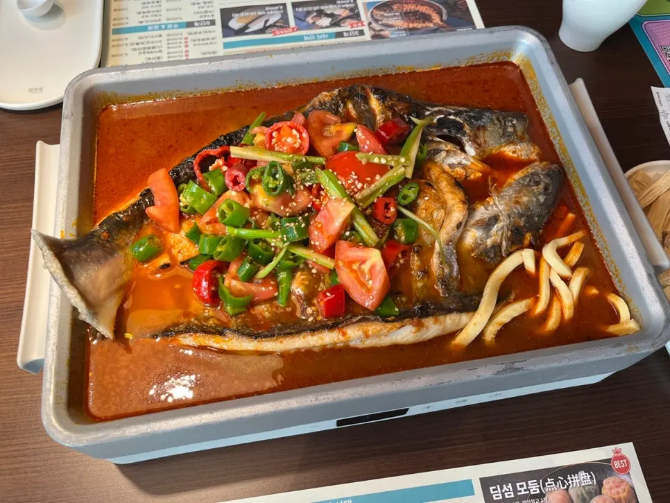 A full tomato kaoyu spread with a large ningbo fish