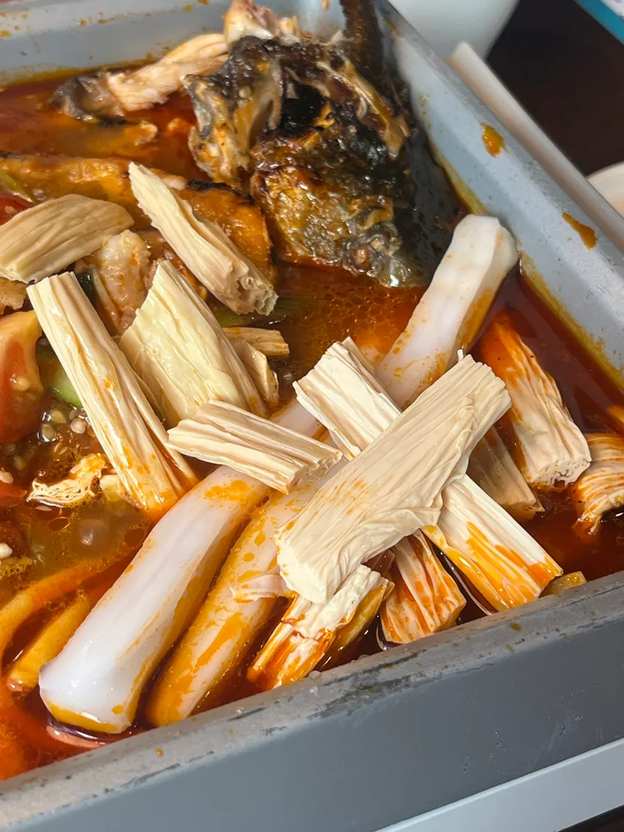 Fuzhu simmering in the tomato broth
