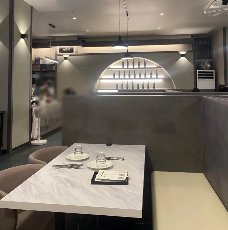 The white-and-gray-toned interior of Plate Dunsan Branch