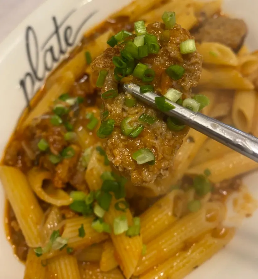 Fresh pasta noodles coated in sauce