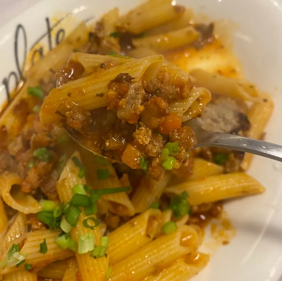 Bolognese pasta topped with meatballs