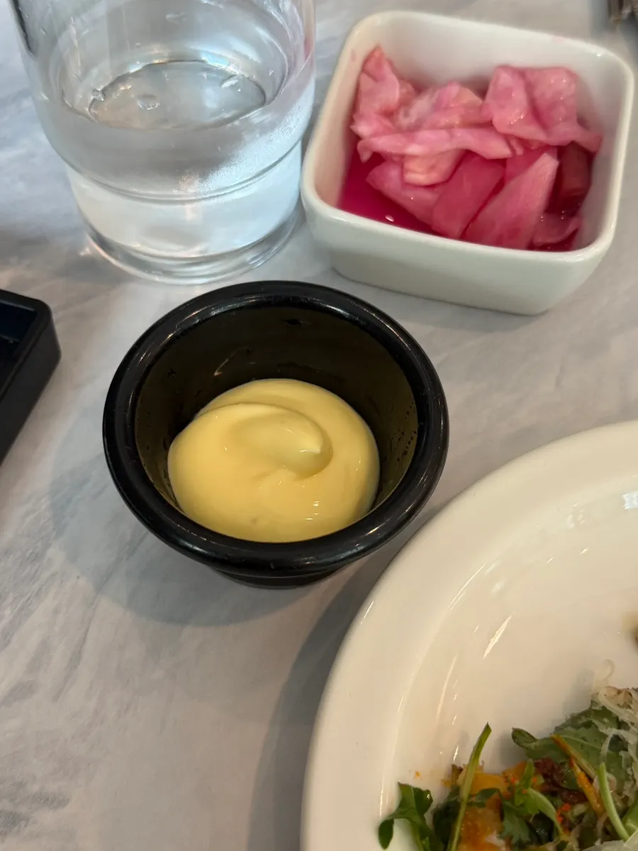 Dipping sauce served alongside the pizza