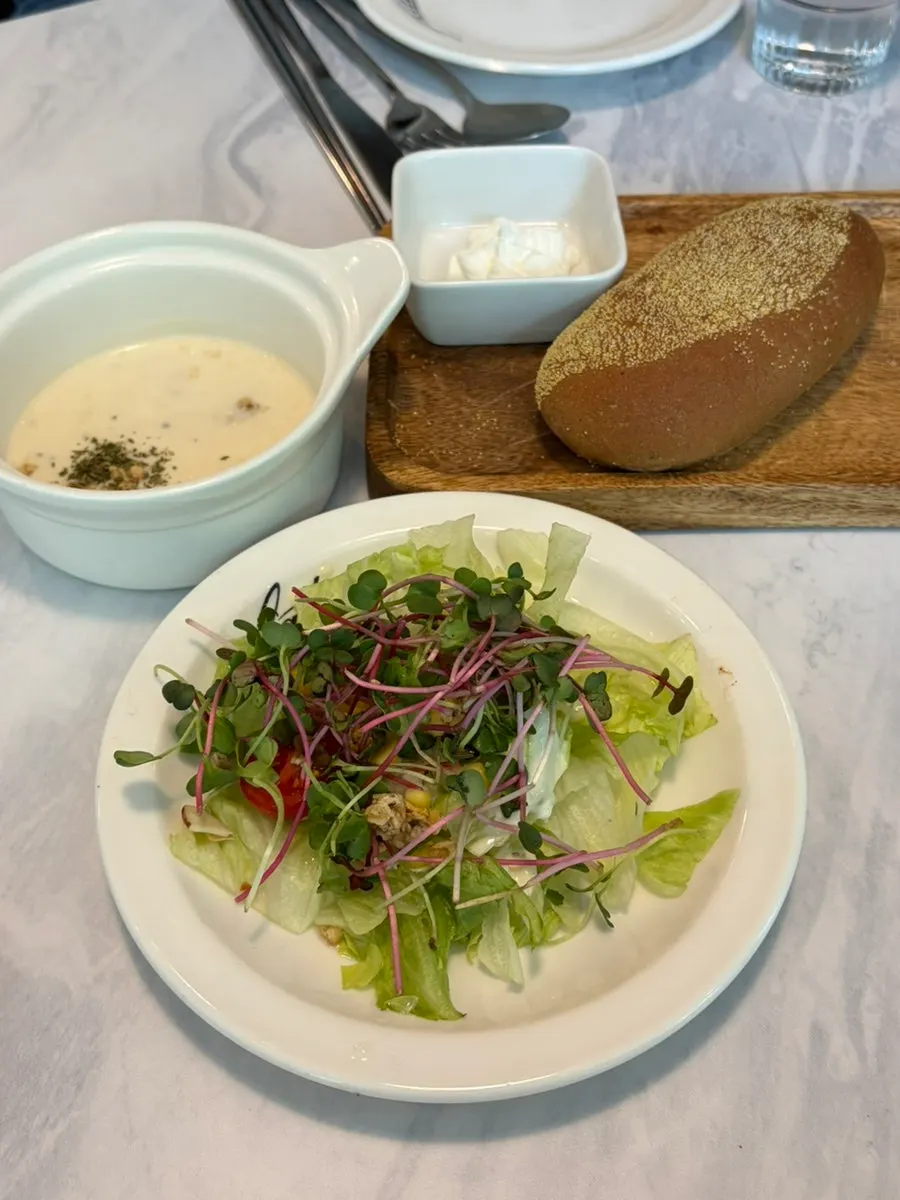Set menu with salad, bread, and corn soup