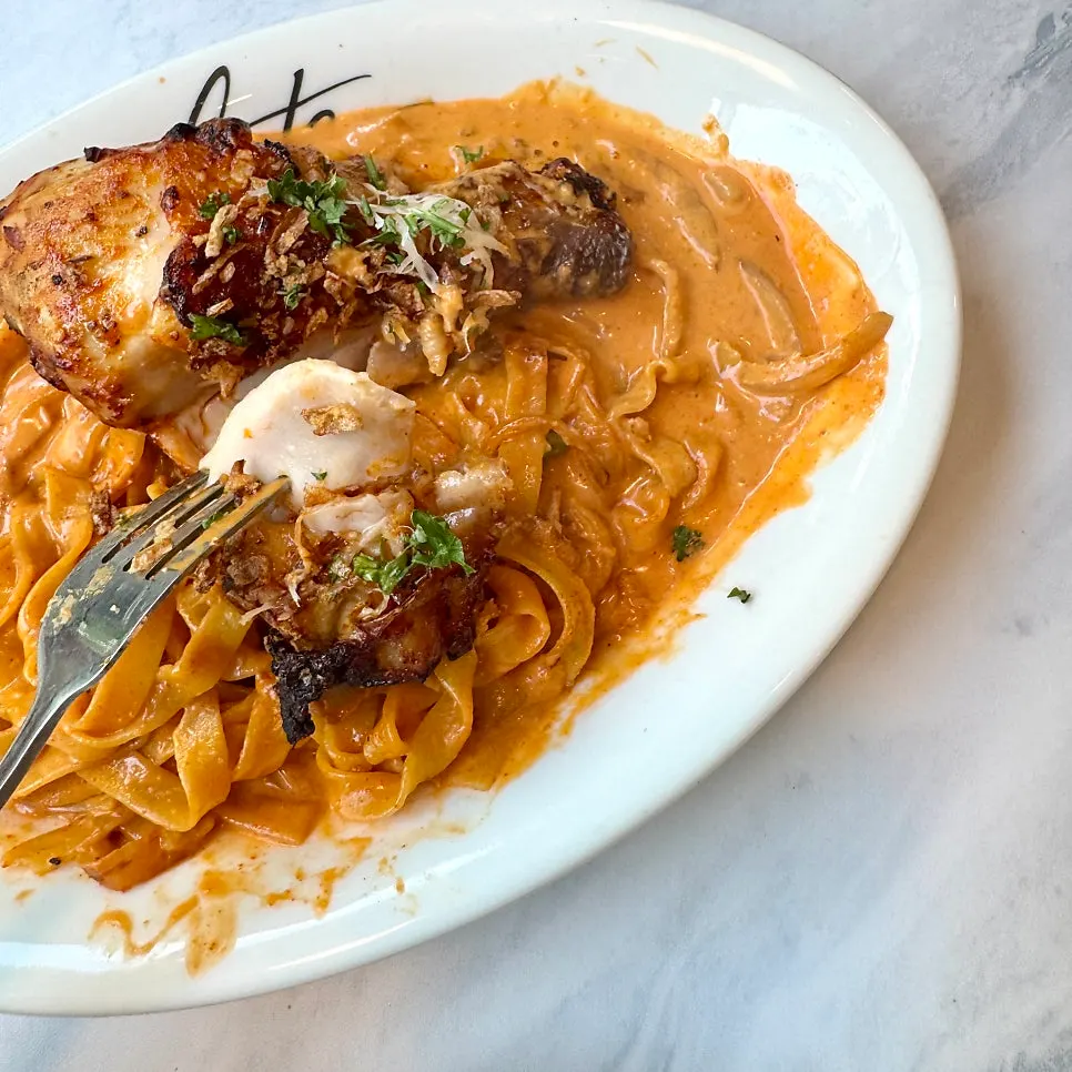 Rosé sauce pasta with a whole chicken drumstick