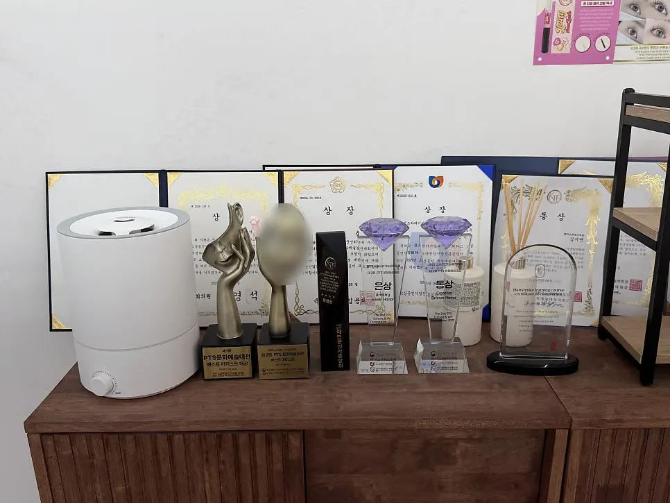Many certificates displayed on the wall