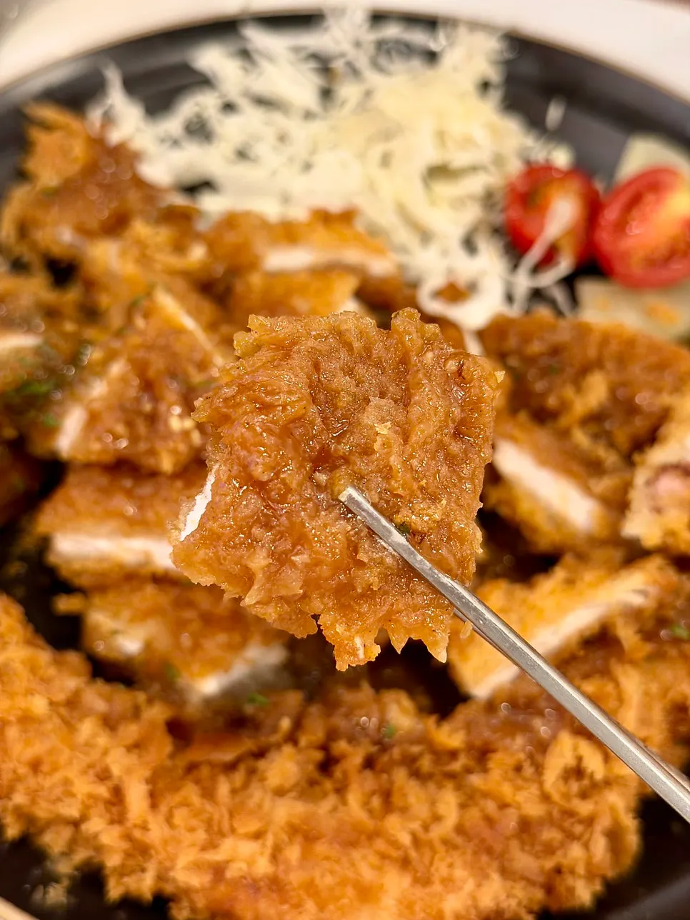 Katsu served with cabbage and cherry tomatoes