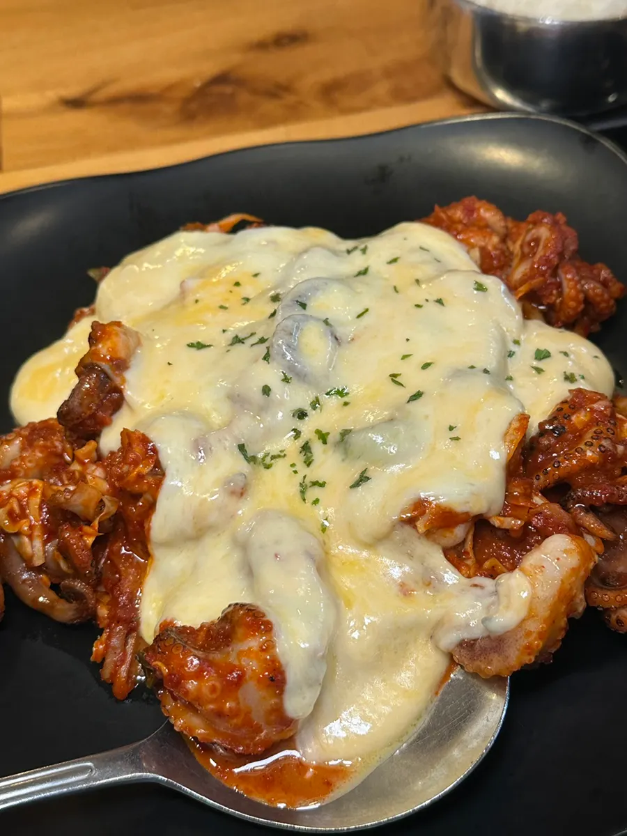 Octopus stir-fry for two topped with cheese