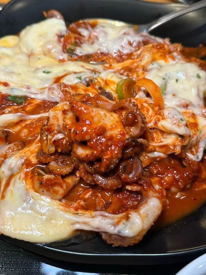 Fire-grilled octopus wrapped in melted cheese