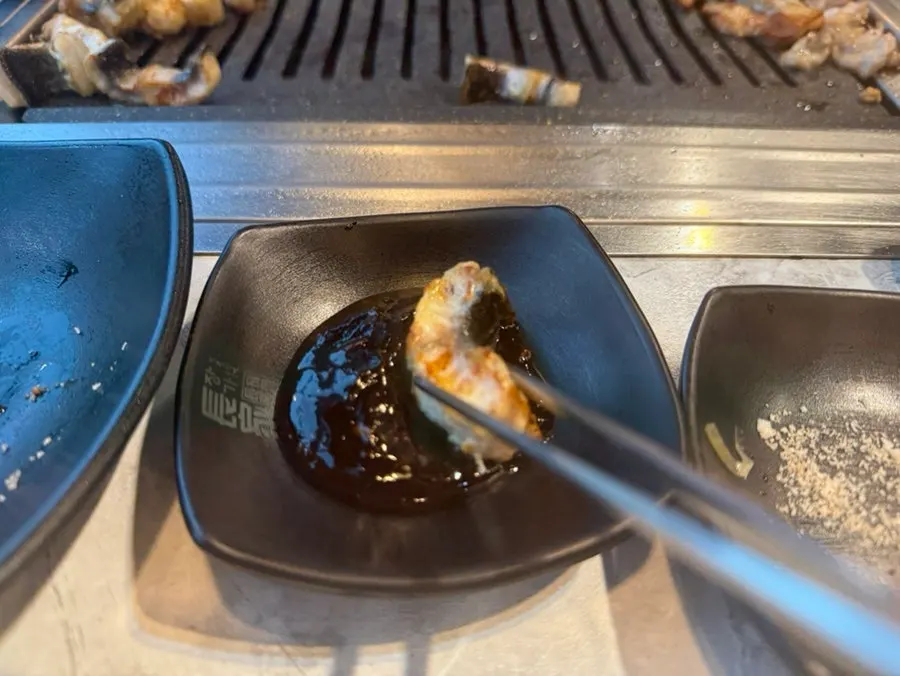 Dipping eel into the sauce