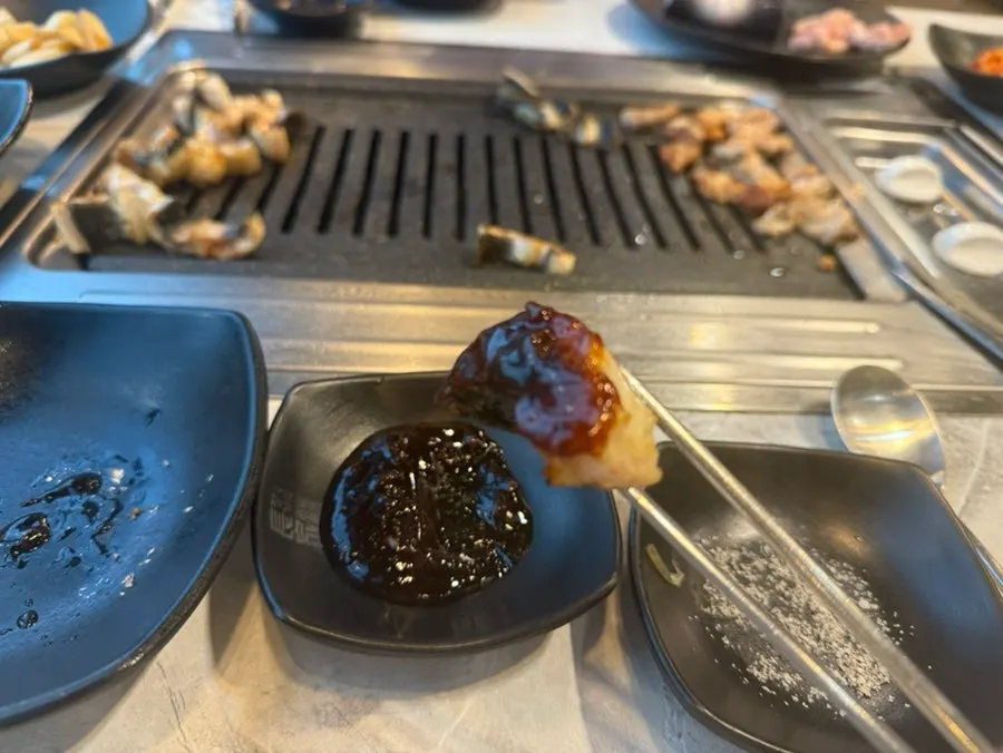 Plenty of eel sauce prepared on the table