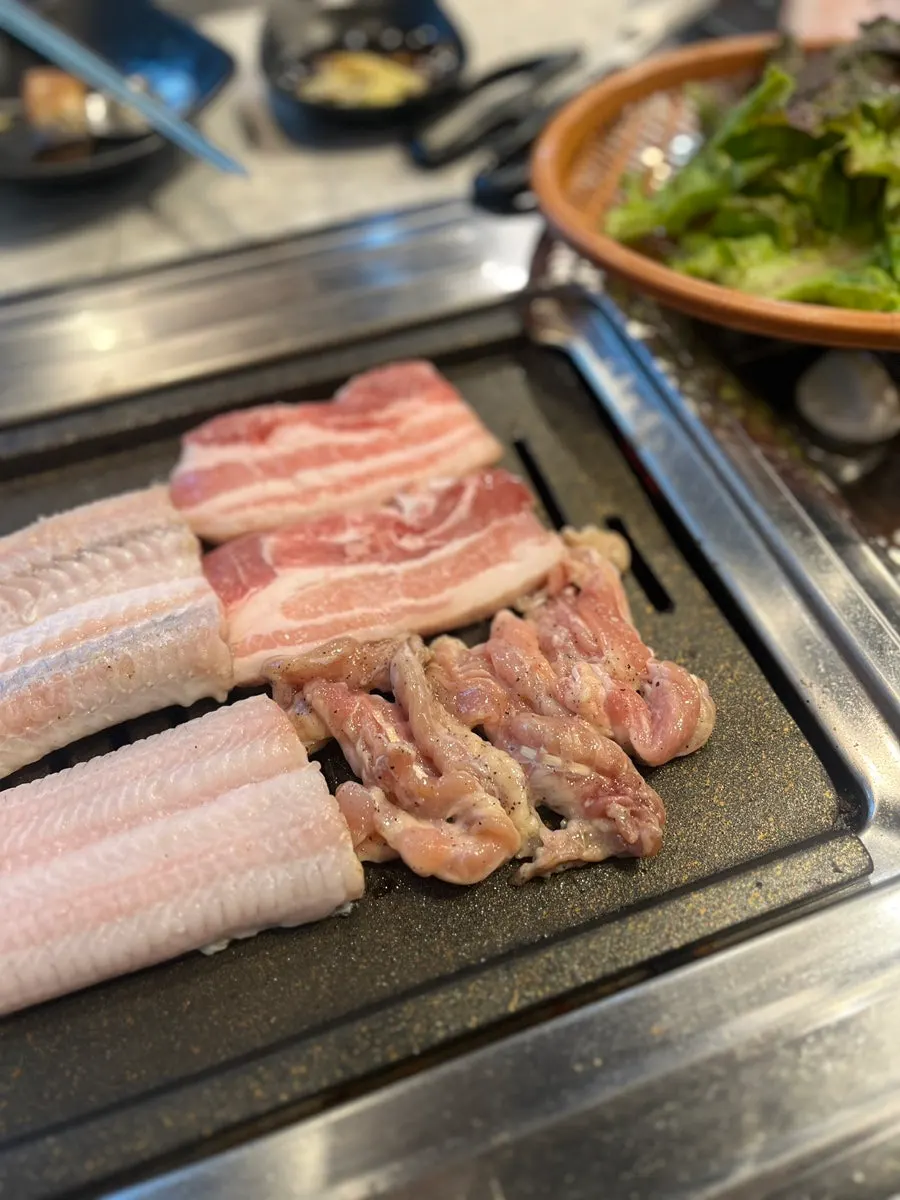 Grill with eel and meat cooking together