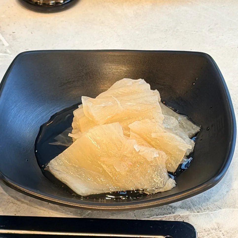 Side dishes of pickled onions and pickled perilla leaves