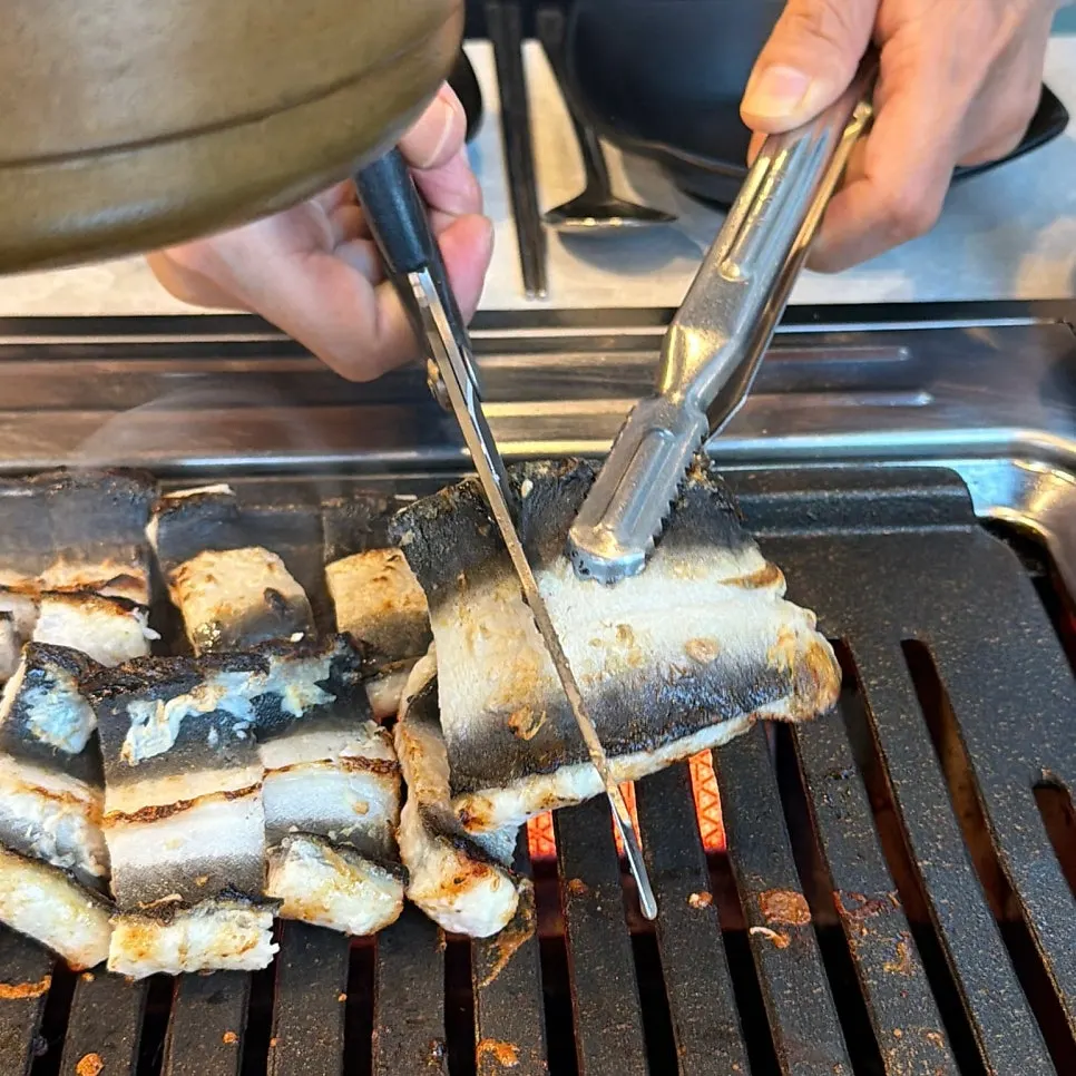 Eel grilling skin-side down on the grill