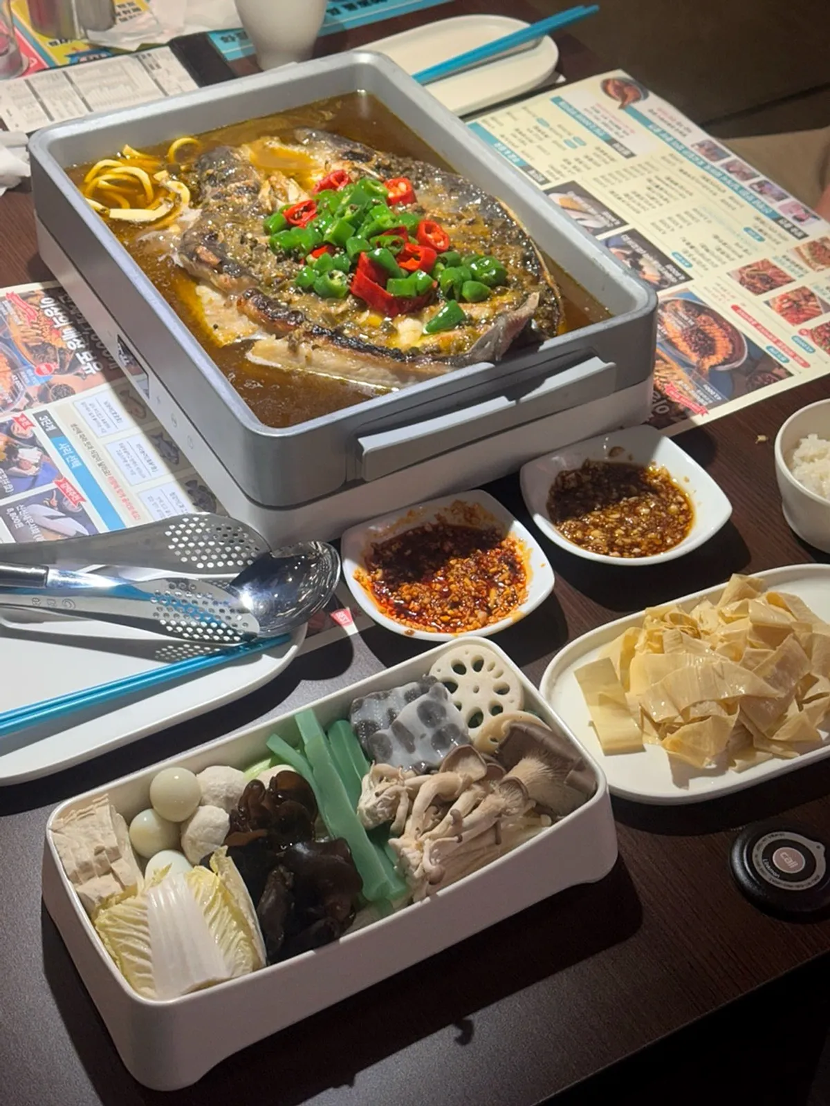 A full spread of kaoyu with assorted add-ons