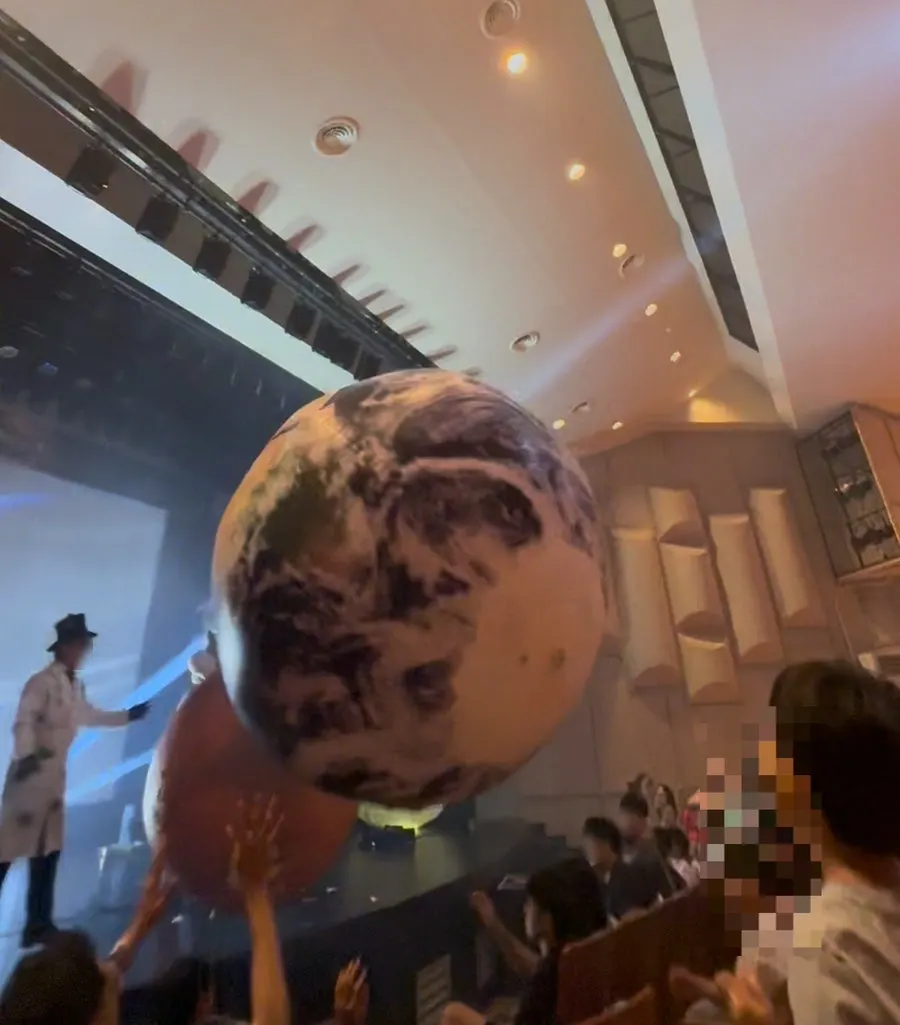 A planet-shaped balloon rolled out into the audience