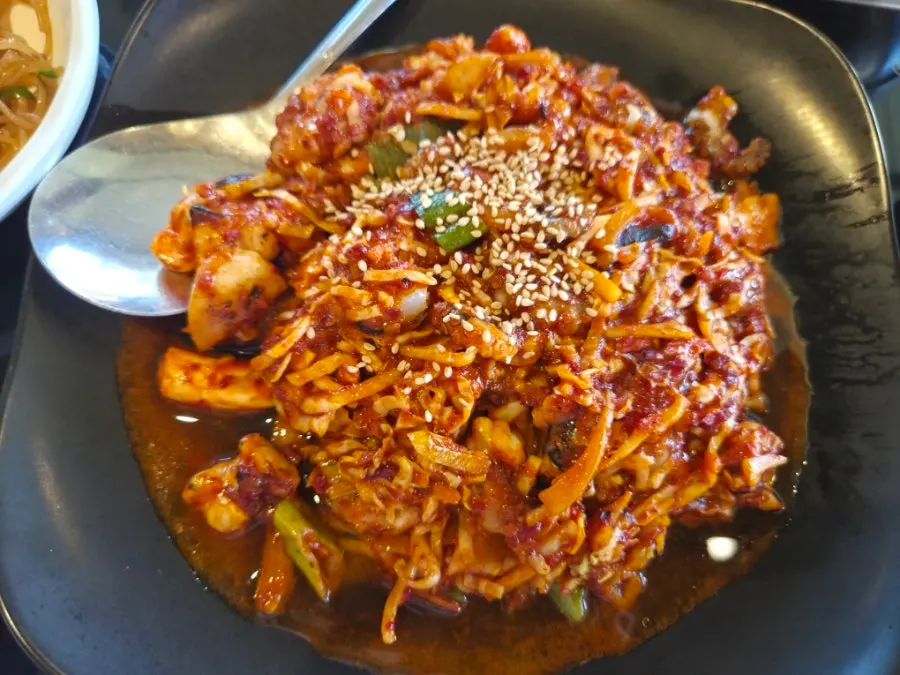 Fire-grilled octopus stir-fry meal with a smoky aroma