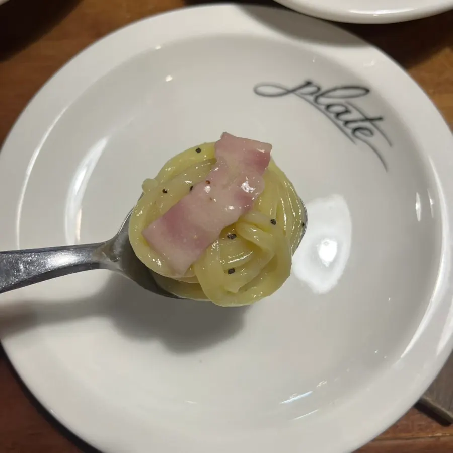 Bacon cacio e pepe topped generously with pepper