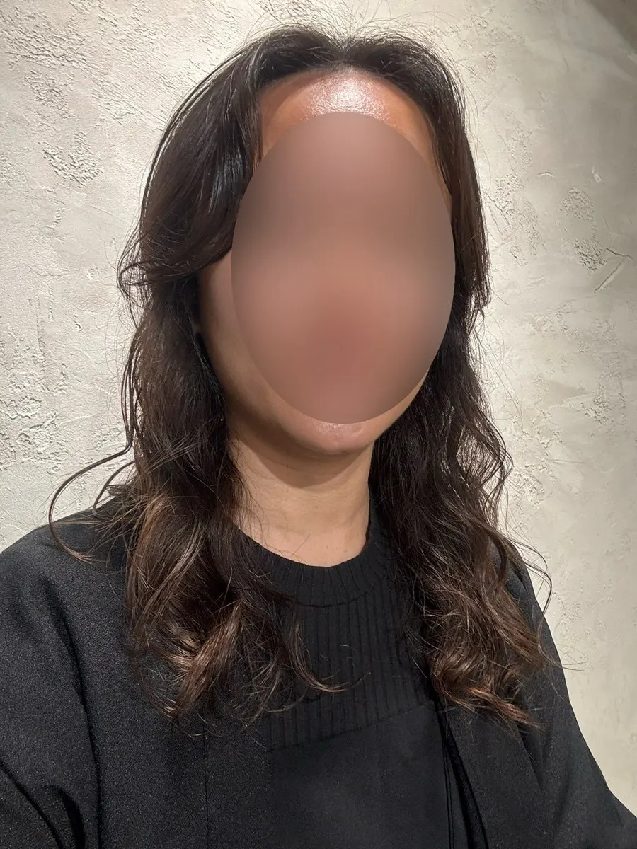 Side view of the finished chest-length S-curl waves