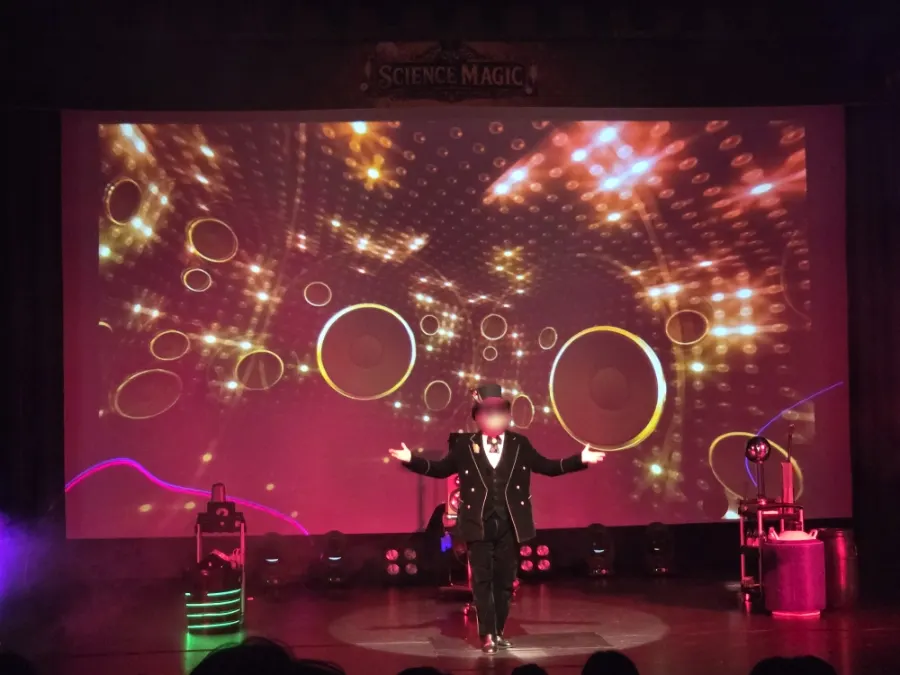 Stage scene showing a magic trick with a scientific principle