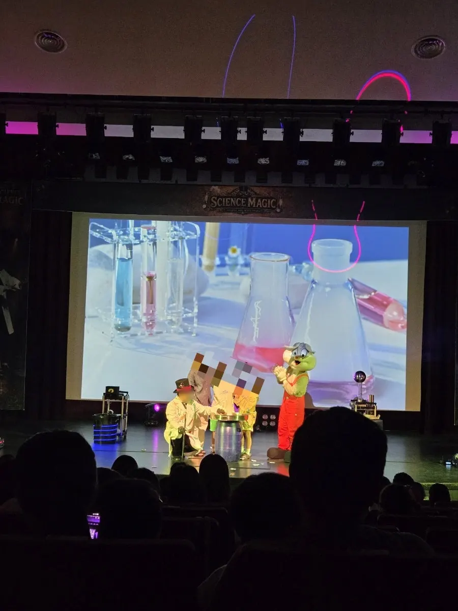Audience members joining in on a magic trick on stage